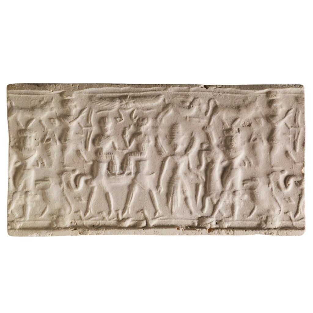 Image of a carved hematite Syrian seal depicting a two-humped camel with two people of its back.